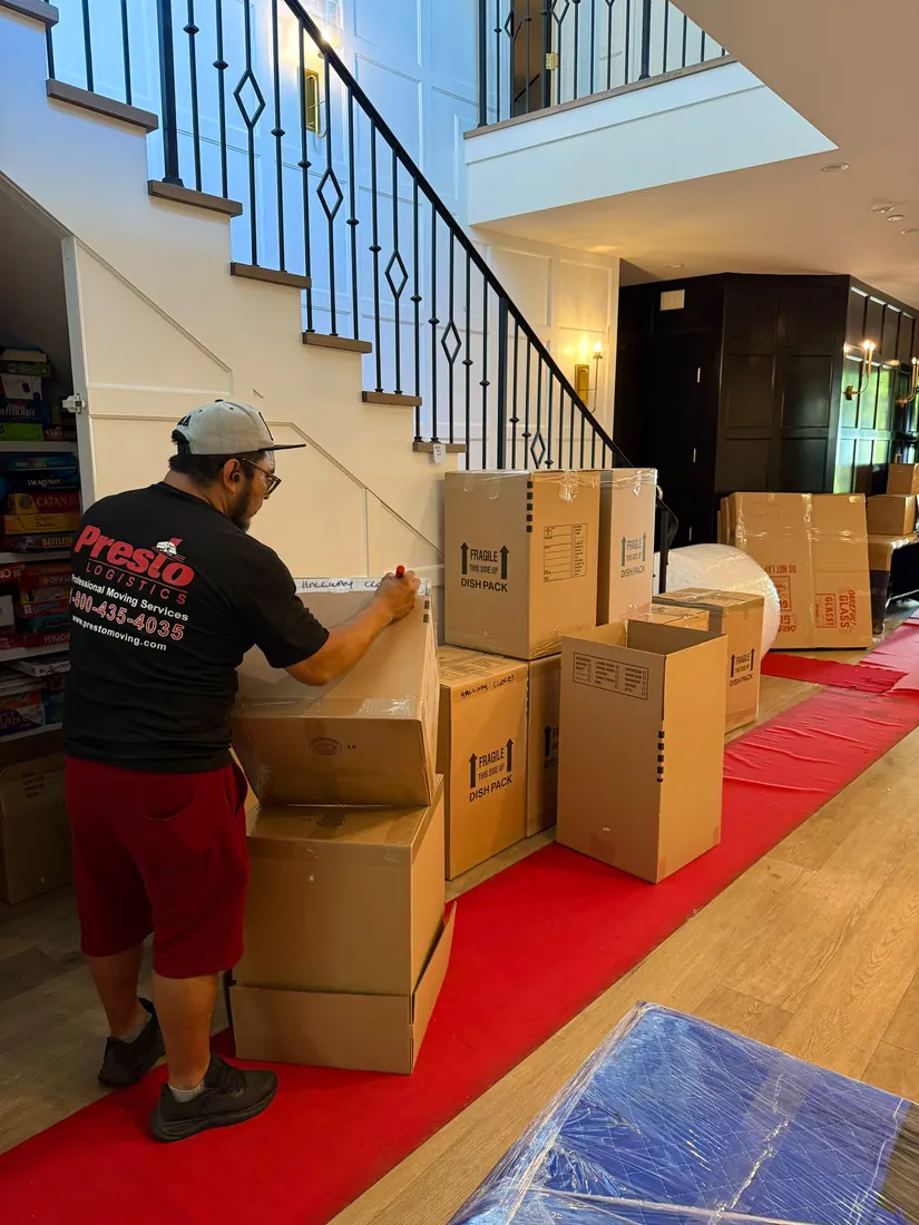 Presto crew carrying boxes on moving day