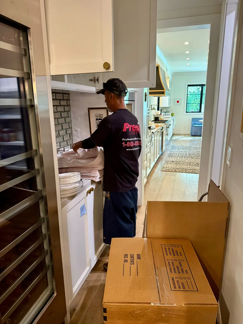 Presto mover packing a kitchen into boxes