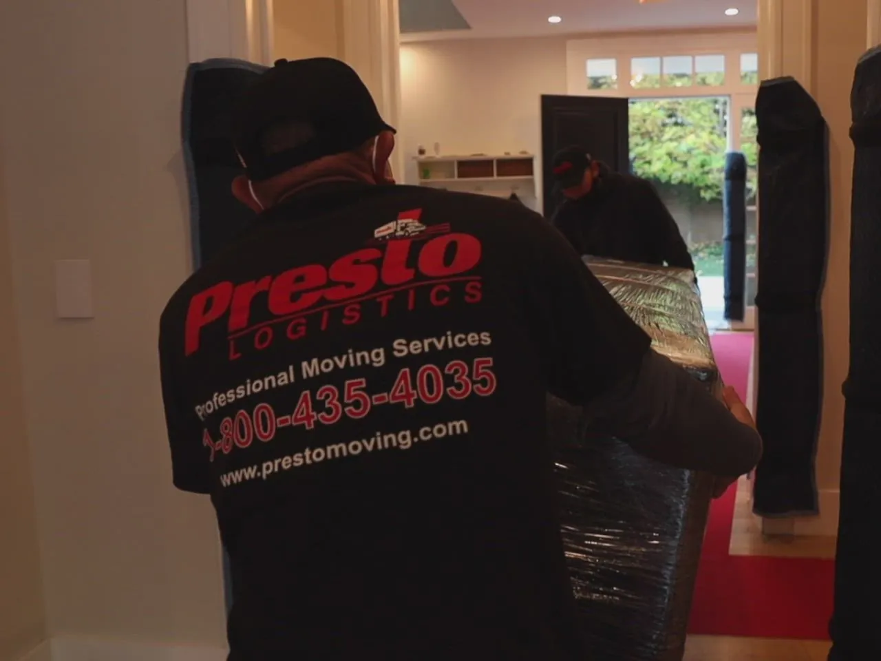 Presto Logistics mover in a company shirt